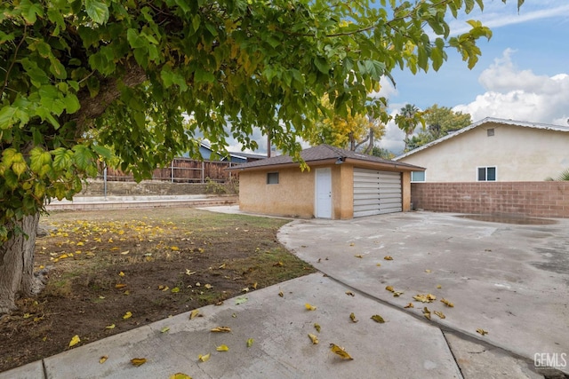 exterior space with a garage and an outdoor structure