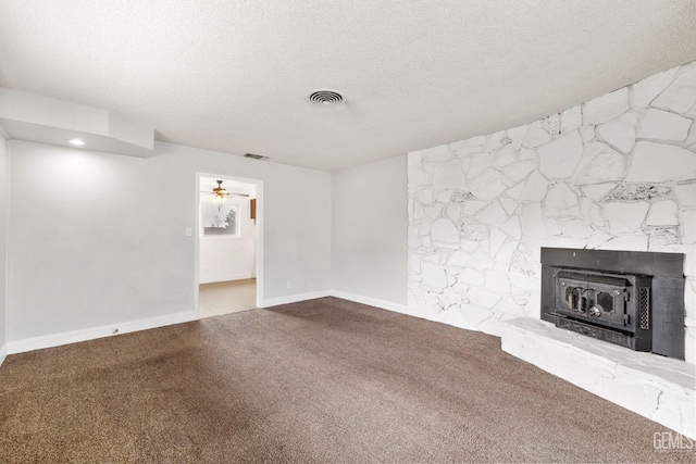 unfurnished living room with carpet flooring and a textured ceiling