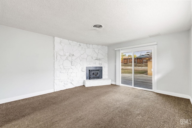 unfurnished living room featuring carpet and a textured ceiling