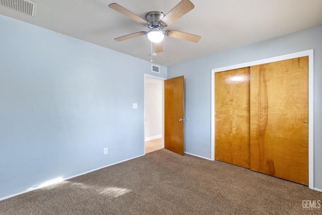 unfurnished bedroom featuring ceiling fan, a closet, and carpet floors