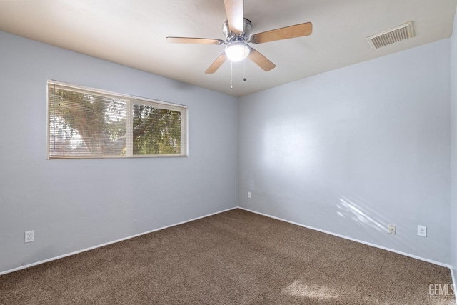 carpeted spare room with ceiling fan