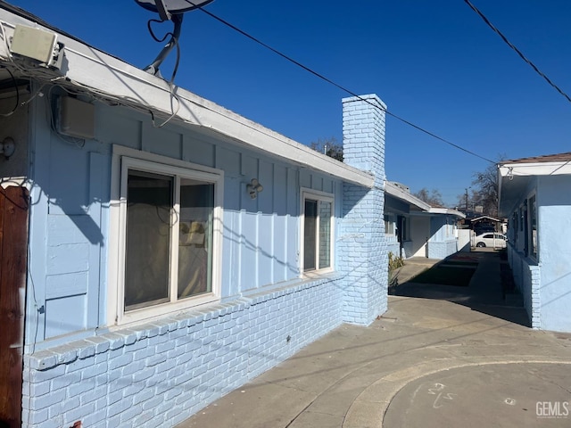 view of side of property featuring a patio area