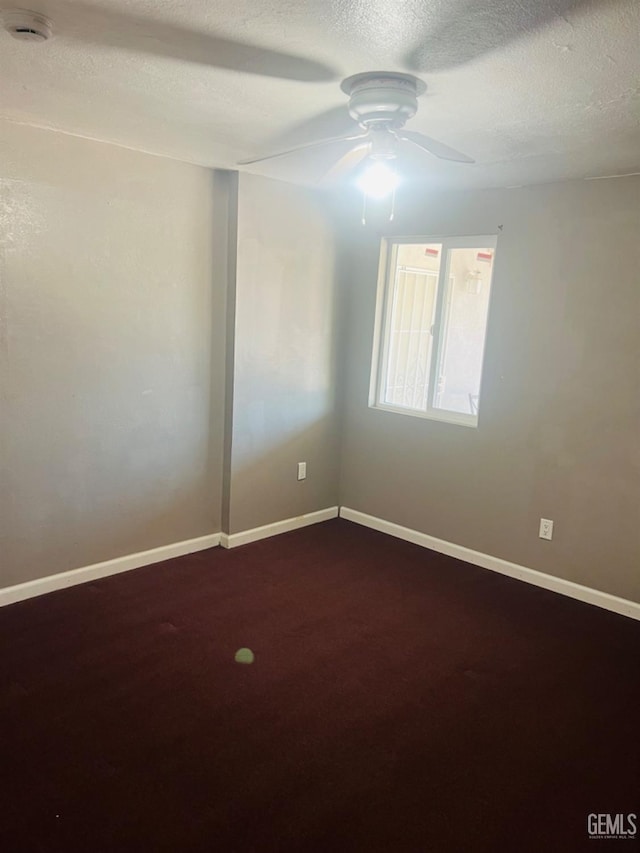 1026 Height St, Bakersfield, CA 93305 - unfurnished room with a smoke detector, a ceiling fan, a textured ceiling, and dark colored carpet
