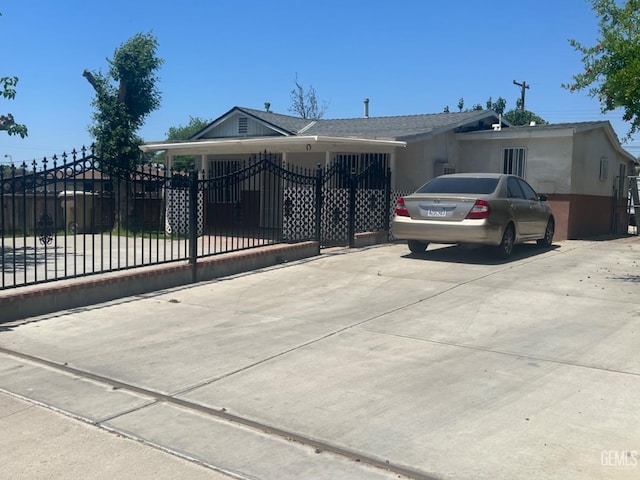 1026 Height St, Bakersfield, CA 93305 - view of front of house with concrete driveway and stucco siding