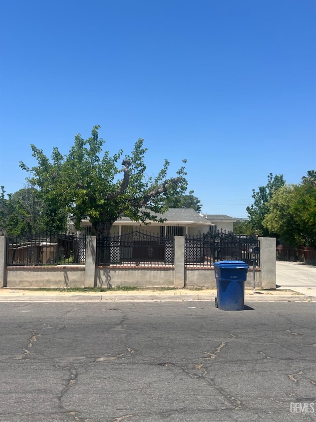 1026 Height St, Bakersfield, CA 93305 - view of property hidden behind natural elements with a fenced front yard