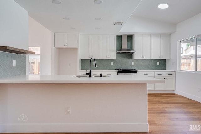3702 Bedrock Dr, Bakersfield, CA 93311 - kitchen featuring wall chimney exhaust hood, a sink, stainless steel range, backsplash, and white cabinetry
