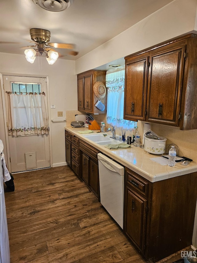 5708 Cypress Point Dr, Bakersfield, CA 93309 - kitchen featuring white dishwasher, a ceiling fan, dark wood-style floors, dark brown cabinetry, and decorative backsplash