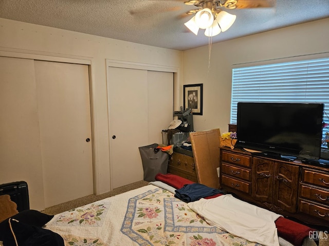 5708 Cypress Point Dr, Bakersfield, CA 93309 - carpeted bedroom with two closets, a textured ceiling, and a ceiling fan