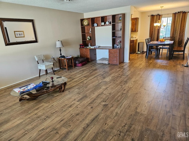 5708 Cypress Point Dr, Bakersfield, CA 93309 - sitting room with a chandelier, dark wood-type flooring, and a textured ceiling