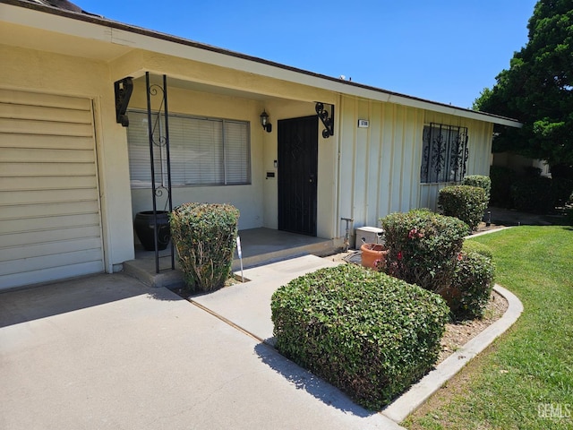 5708 Cypress Point Dr, Bakersfield, CA 93309 - property entrance with board and batten siding and a lawn