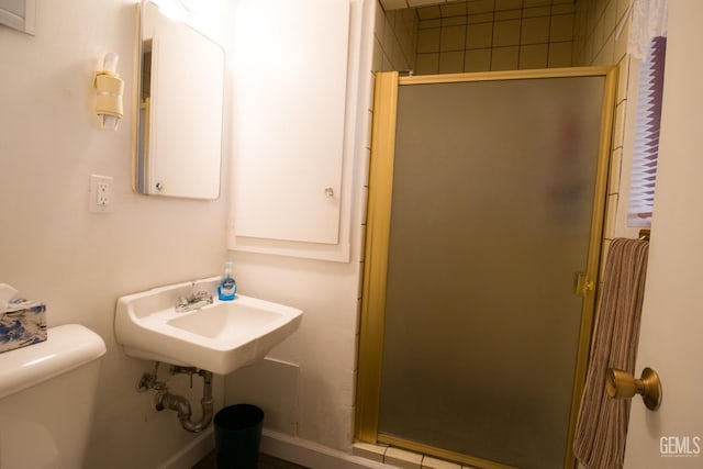 full bath with a sink, a shower stall, and toilet