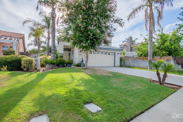 view of front of house with a garage and a front lawn