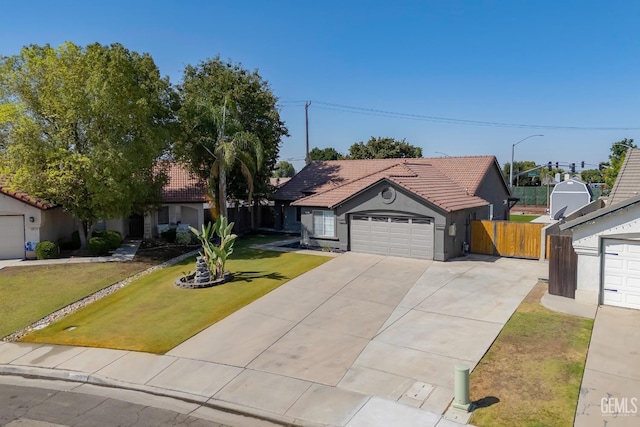 12017 Hannah Denise Ave, Bakersfield, CA 93312 - ranch-style house featuring concrete driveway, an attached garage, a tiled roof, and stucco siding