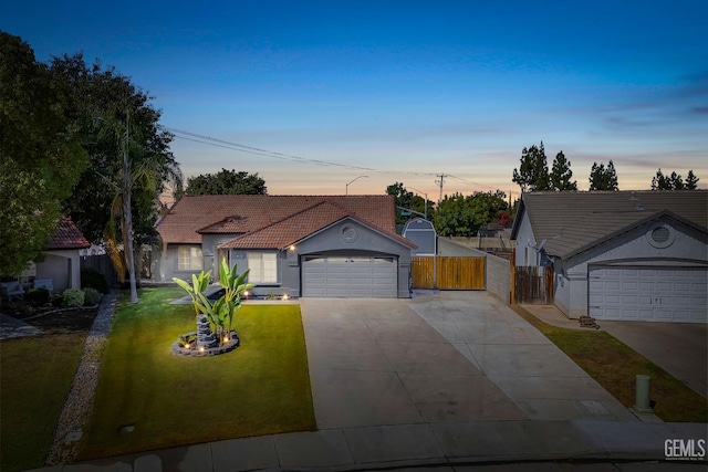 12017 Hannah Denise Ave, Bakersfield, CA 93312 - view of front of property featuring concrete driveway, a tile roof, stucco siding, a garage, and a gate