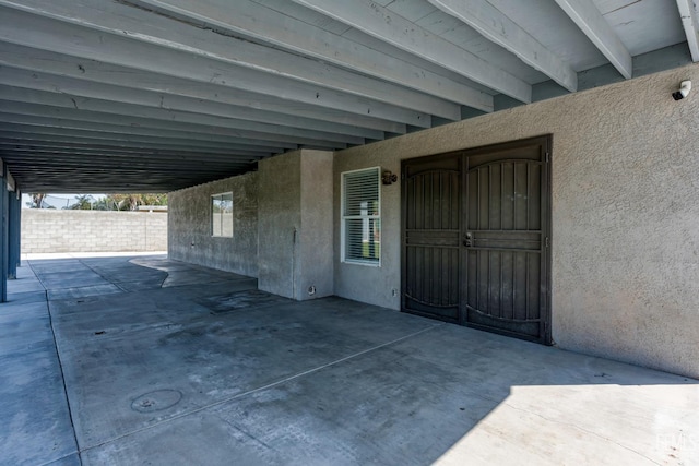 12017 Hannah Denise Ave, Bakersfield, CA 93312 - doorway to property with stucco siding, a patio area, a carport, and a security system
