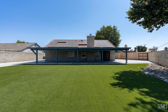 12017 Hannah Denise Ave, Bakersfield, CA 93312 - rear view of house featuring roof mounted solar panels, a patio, and a fenced backyard