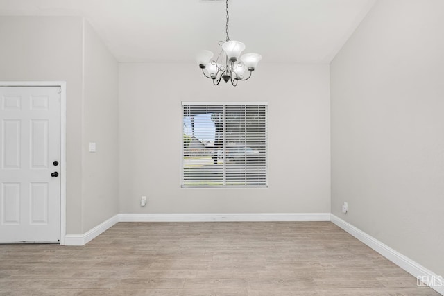 12017 Hannah Denise Ave, Bakersfield, CA 93312 - unfurnished dining area with a chandelier and wood finished floors