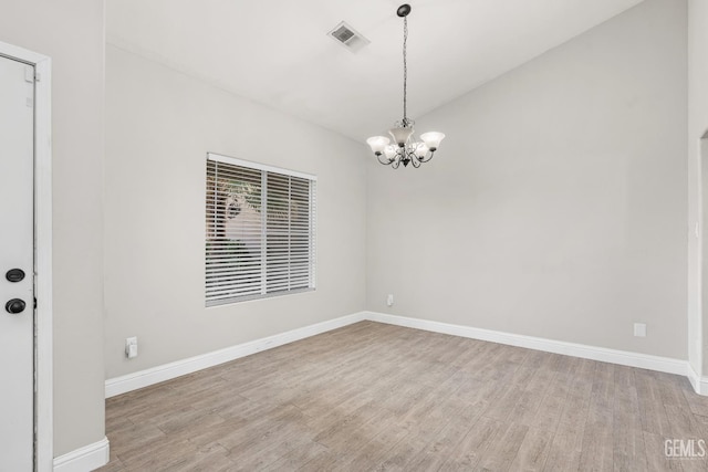 12017 Hannah Denise Ave, Bakersfield, CA 93312 - spare room featuring a chandelier, light wood finished floors, and vaulted ceiling