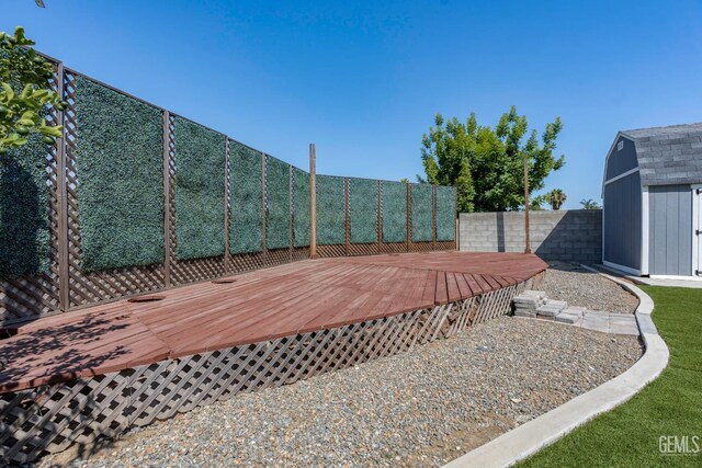 12017 Hannah Denise Ave, Bakersfield, CA 93312 - wooden terrace with a storage unit and a fenced backyard