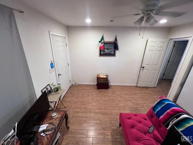 sitting room featuring ceiling fan and wood-type flooring