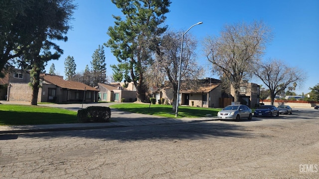 view of front of home with a residential view and a front yard