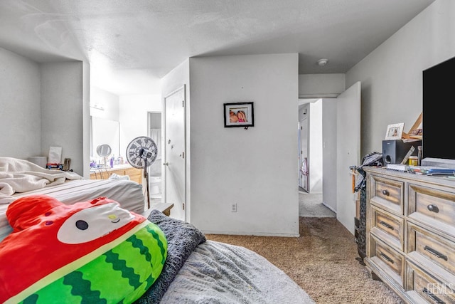 carpeted bedroom featuring a textured ceiling