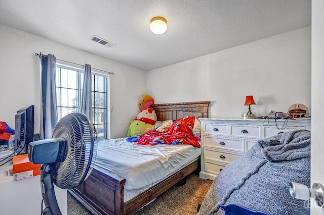 carpeted bedroom with a textured ceiling