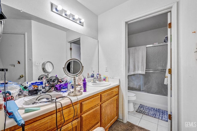 full bathroom featuring tile patterned floors, vanity, toilet, and enclosed tub / shower combo