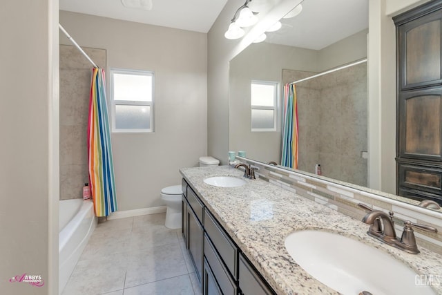 full bathroom featuring tile patterned floors, vanity, toilet, and a wealth of natural light