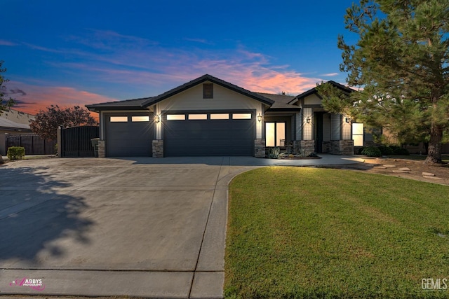 view of front of property with a garage and a yard