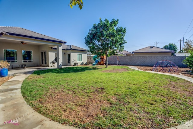 view of yard featuring a patio and ceiling fan