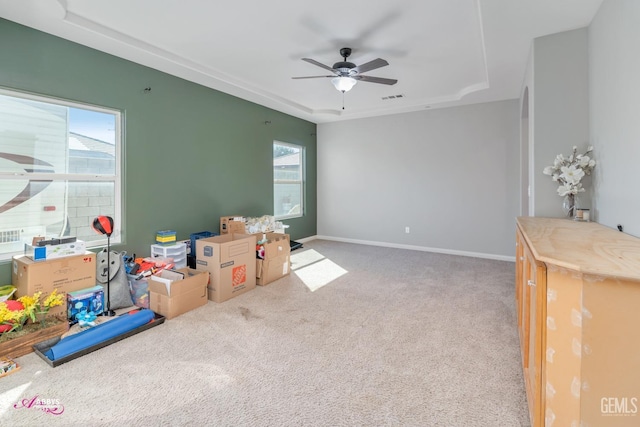 game room featuring carpet flooring, a raised ceiling, and ceiling fan