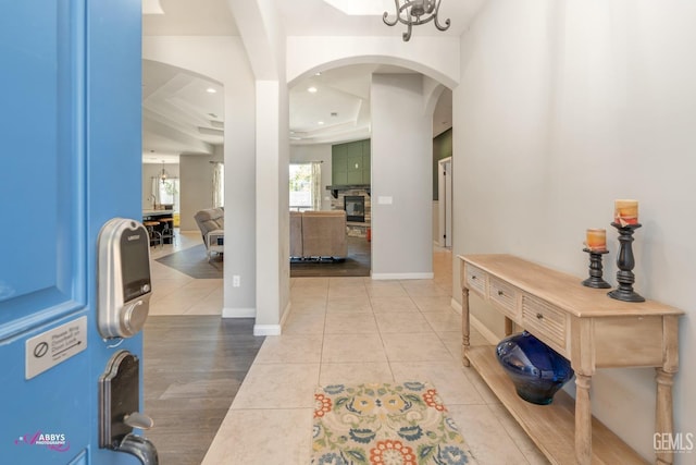 entrance foyer with a raised ceiling and light tile patterned flooring