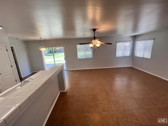 9809 Battersea Park Dr, Bakersfield, CA 93312 - spare room featuring dark tile patterned flooring, baseboards, and a ceiling fan