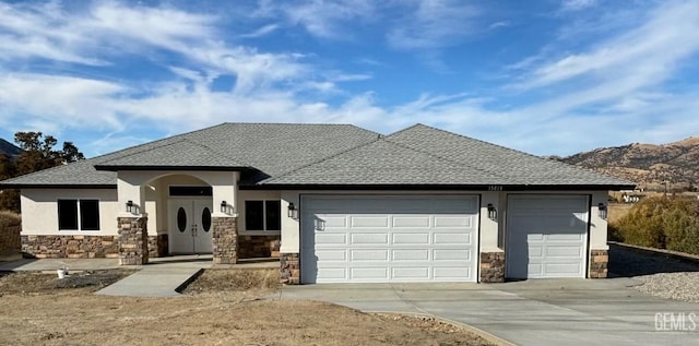 view of front facade featuring a mountain view and a garage