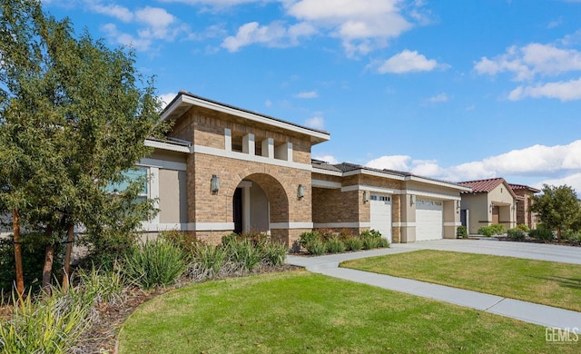 view of front of home featuring a garage, driveway, a front yard, and brick siding