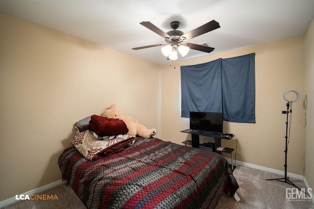 carpeted bedroom with baseboards and ceiling fan