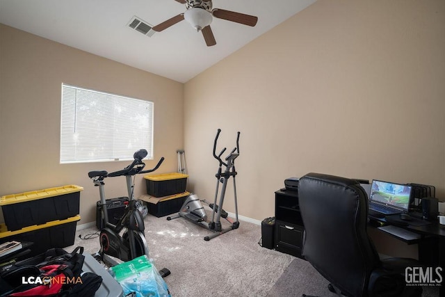 carpeted home office with visible vents, baseboards, ceiling fan, and vaulted ceiling