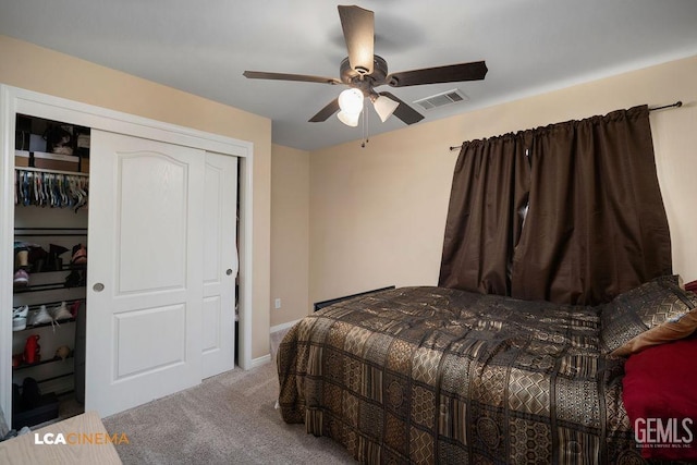 carpeted bedroom featuring a closet, visible vents, and ceiling fan