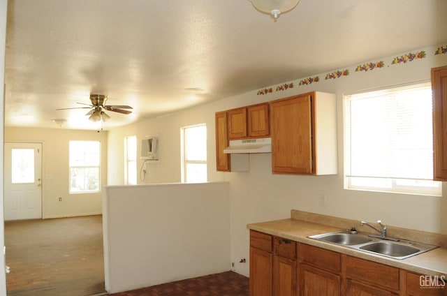 kitchen featuring sink, a wall mounted air conditioner, dark parquet flooring, and ceiling fan