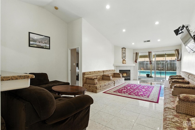 3023 Esperanza Dr, Bakersfield, CA 93313 - living room with light tile patterned floors, lofted ceiling, a tile fireplace, and recessed lighting