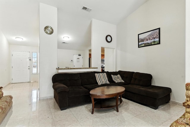 3023 Esperanza Dr, Bakersfield, CA 93313 - living area featuring light tile patterned floors and vaulted ceiling