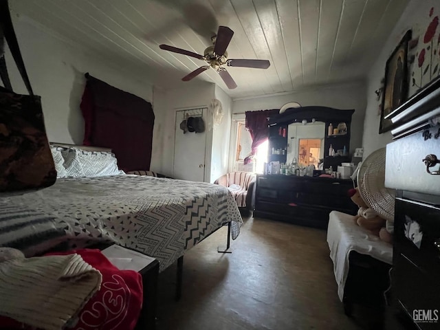 bedroom featuring wood ceiling, ceiling fan, and concrete floors