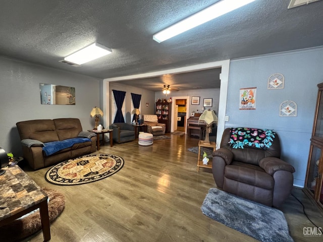 220 Tyler St, Taft, CA 93268 - living room featuring a textured ceiling, wood finished floors, and a ceiling fan