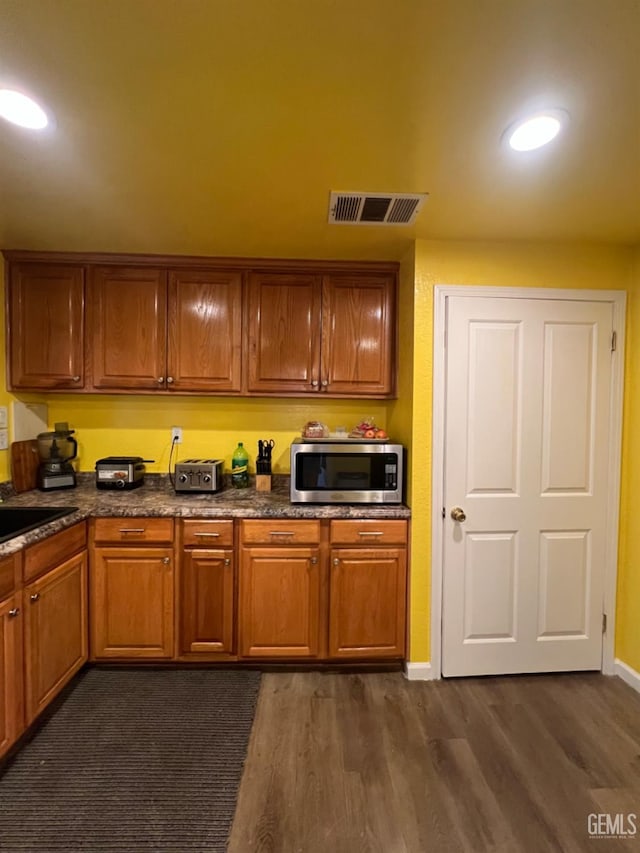 220 Tyler St, Taft, CA 93268 - kitchen featuring stainless steel microwave, dark wood finished floors, baseboards, recessed lighting, and a sink