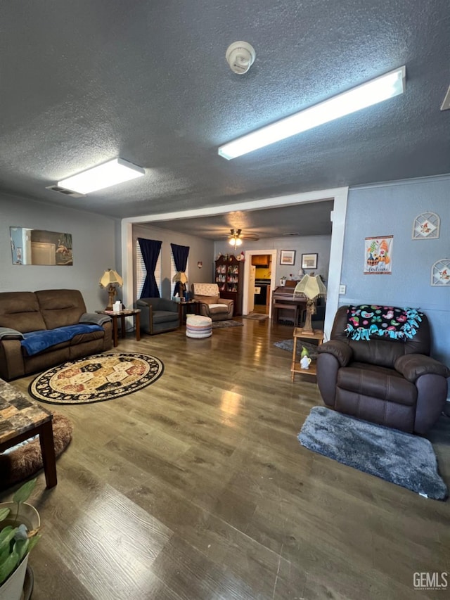220 Tyler St, Taft, CA 93268 - living area with a textured ceiling, wood finished floors, and ceiling fan
