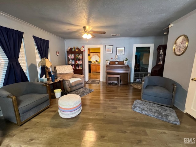 220 Tyler St, Taft, CA 93268 - living room featuring a textured ceiling, crown molding, wood finished floors, and ceiling fan
