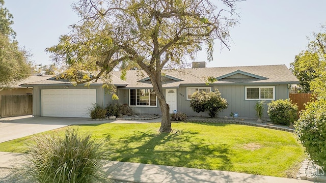 ranch-style home with a front yard and a garage