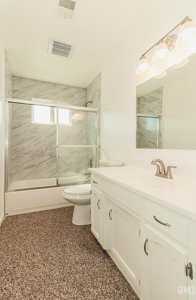 full bathroom with vanity, toilet, and bath / shower combo with glass door