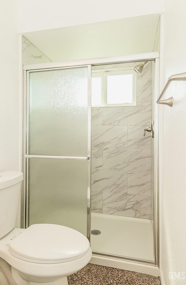 bathroom with an enclosed shower and toilet